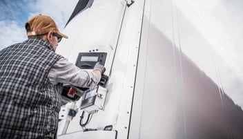 A worker inspecting a humidity and temperature device