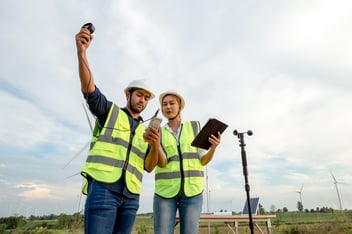 Man, and Women monitoring air humidity with a sensor